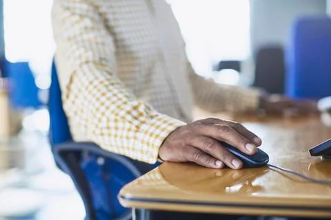 Businessman using computer mouse at desk Foto stock