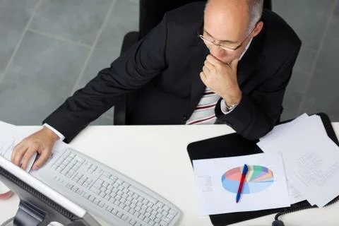 Businessman using computer at office desk Stock Photos