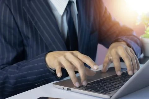 Businessman using a computer or laptop to work and communicate Stock Photos