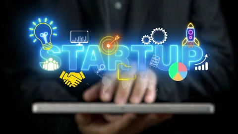 Businessman using computer to show glowing neon line of business startup word Stock-Footage 255701539