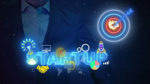 Businessman using computer to show glowing neon line of business startup word Stock-Footage 256023407