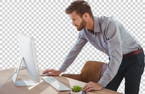 Businessman using computer while standing at desk Stockfoto's