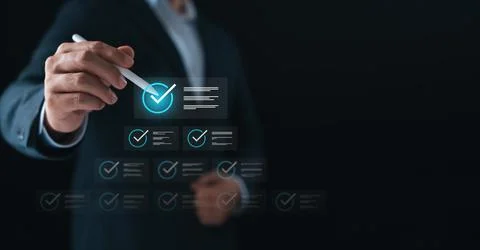 Businessman using digital checklist interface with pen, symbolizing task ma.. Stock Photos