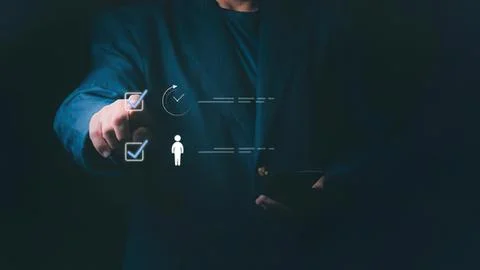 Businessman using digital checkmarks on transparent screen Stock Photos