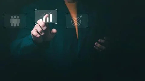 Businessman using digital interface with charts and icons Stock Photos
