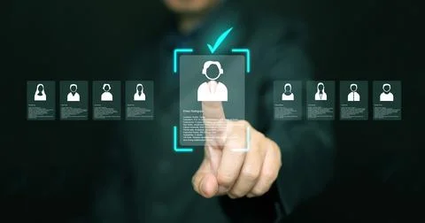 Businessman using digital interface to review candidate profiles and select.. Stock Photos