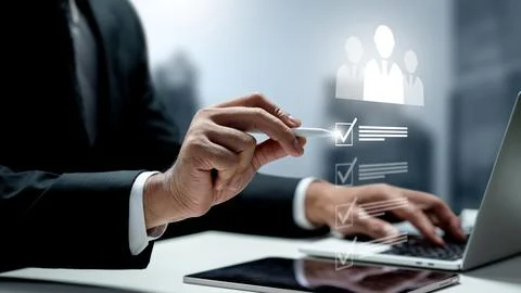 Businessman using a digital pen to select candidates from a holographic che.. Stock Photos