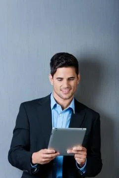 Businessman using digital table against blue wall Stock Photos