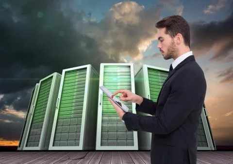 Businessman using digital tablet against server systems in sky Stock Photos