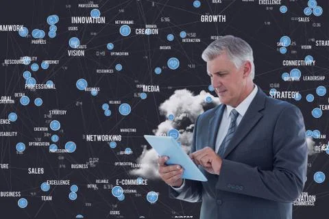 Businessman using digital tablet against business terms in background Stock Photos