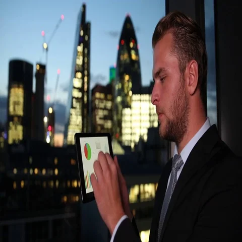 Businessman Using Digital Tablet Analyzing Pie Chart Sales Report London Skyline Stock Footage 69709769