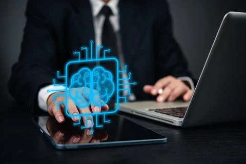 Businessman using digital tablet and laptop, with holographic brain icon ar.. Stock Photos
