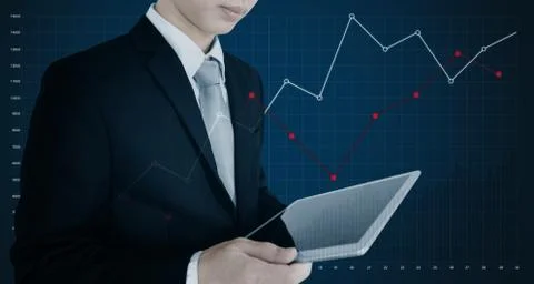 Businessman using digital tablet, on blue background Stock Photos