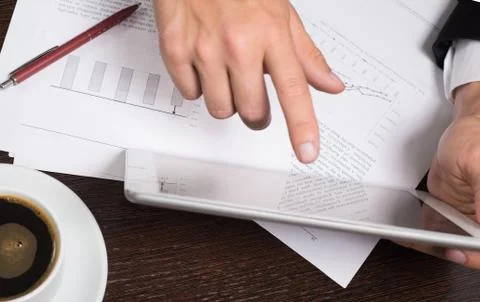Businessman using digital tablet with charts for planning and analysis of bus Stock Photos