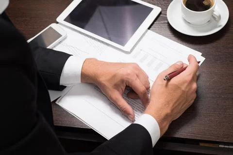 Businessman using digital tablet with charts for planning and analysis of b.. Stock Photos