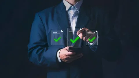 Businessman using digital tablet with checkmark icons Stock Photos