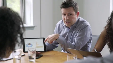 Businessman using digital tablet in meeting Stock Footage 80543341