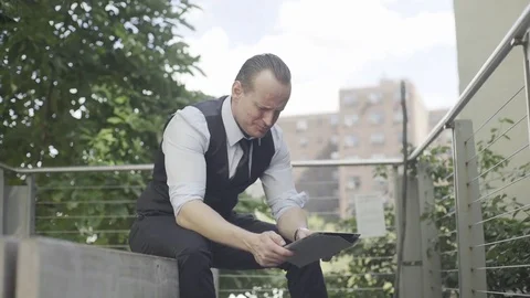 Businessman using digital tablet outdoors Stock Footage 75178008