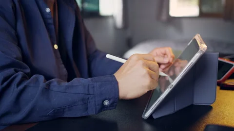 Businessman using digital tablet with stylus pen and analyzing financial ch.. Video stock 345942228