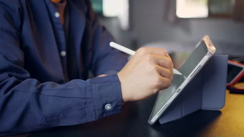 Businessman using digital tablet with stylus pen and analyzing financial ch.. Video stock 345942309
