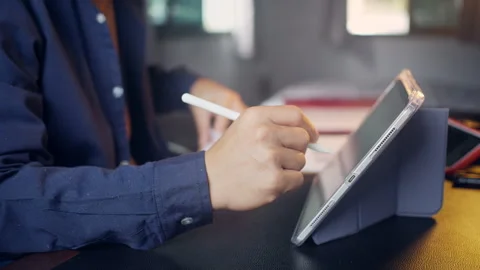 Businessman using digital tablet with stylus pen and analyzing financial ch.. Video stock 345942414