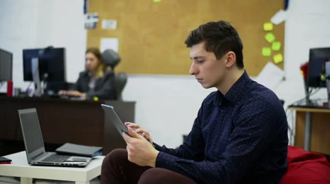 Businessman using electronic tablet in front of offices building Stock Footage 59986606