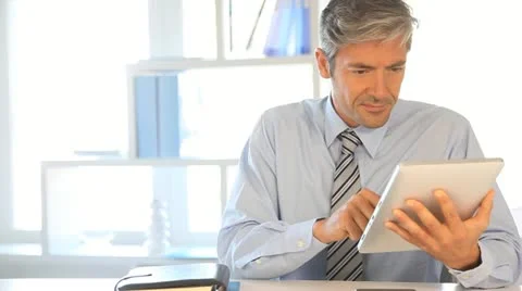Businessman using electronic tablet in office Video stock 14830290