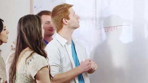 Businessman using graph and showing coworkers Stock Footage 80227309