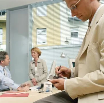 Businessman using a handheld computer Stock Photos