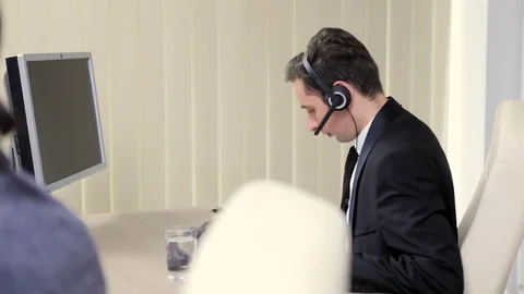 Businessman using headset to talk on the hot line Stock Footage 83758389