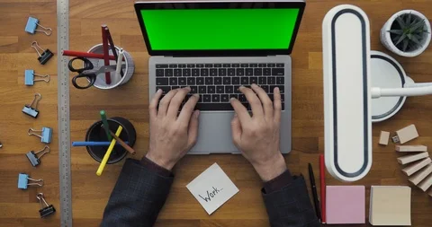 Businessman using his Computer, Working on it. Top view of Laptop with Green Stock Footage 91826561