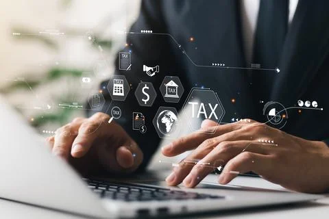 Businessman using his laptop computer to fill out online personal income tax  Stock Photos