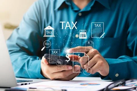 Businessman using his laptop computer and smartphone to fill out online per.. Stock Photos