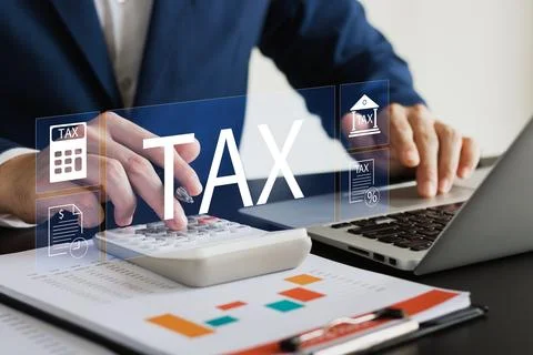 Businessman using his laptop computer to fill out online personal income ta.. Stock Photos