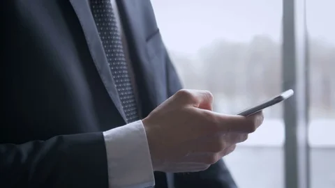 Businessman using his phone in the elevator in the modern office building Stock Footage 75551531