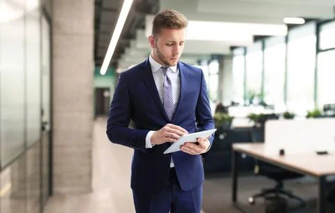 Businessman using his tablet in the office. Stock Photos