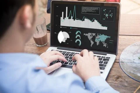 Businessman using laptop analyzing statistics data on laptop screen Stock Photos