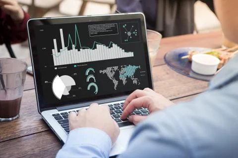 Businessman using laptop analyzing statistics data on laptop screen, working wit Stock Photos