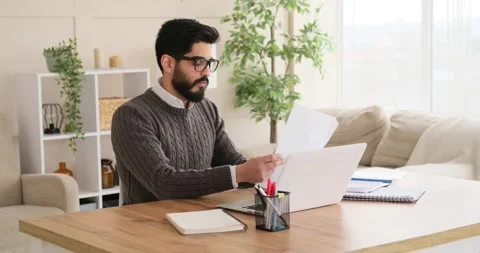 Businessman using laptop and analyzing document Stock Footage 150818939