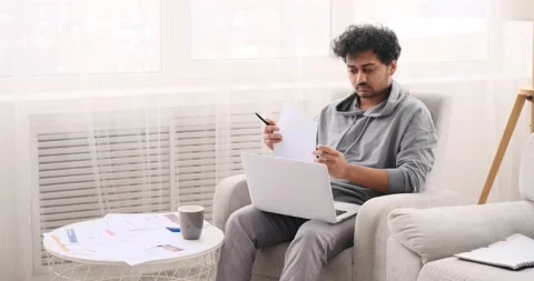 Businessman using laptop and analyzing documents Stock Footage 196079261