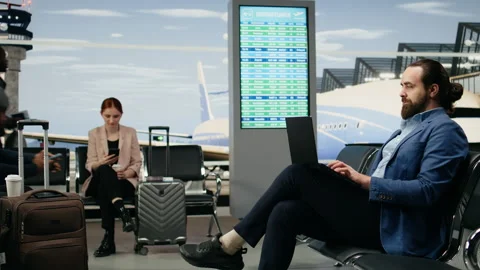 Businessman using laptop and checking smartphone waiting in airport Stock Footage 339642839