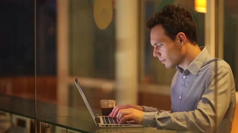 Businessman using laptop and drinking coffee late evening Stock Footage 57948272