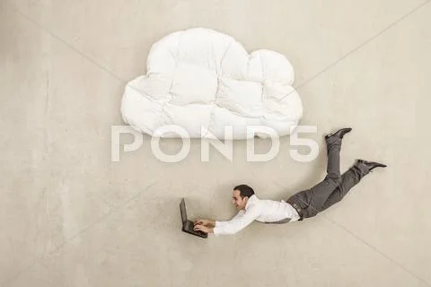 Businessman Using Laptop And Flying Below Cloud Shape Pillow