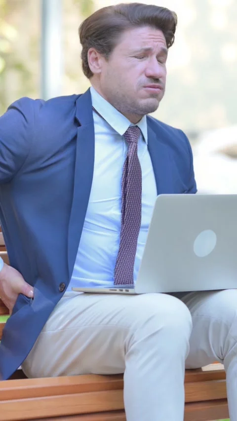 Businessman Using Laptop with Back Pain while Sitting Outdoor, vertical Stock Footage 321119448