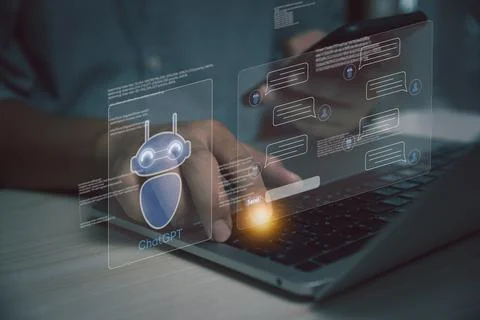 Businessman using laptop computer chatting with a smart AI or artificial in.. 스톡 사진