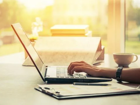 Businessman using laptop computer with document report and coffee in office Stock Photos