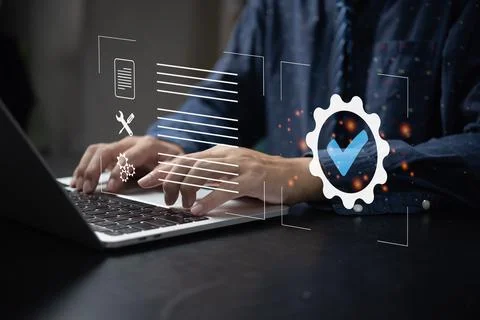 Businessman using laptop computer with quality assurance and document icon fo 写真素材