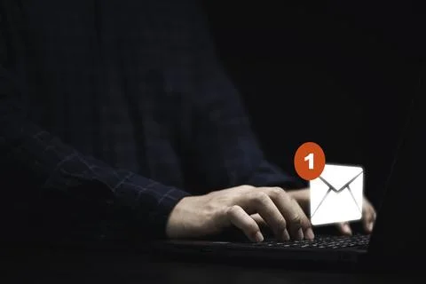 Businessman using laptop computer with white newsletters and notification f.. Stock-Fotos