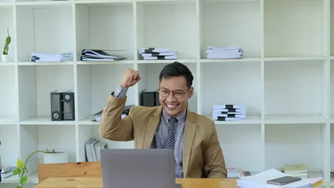 Businessman using laptop Excited the work came out successfully and the goal was Stock Footage 235206145