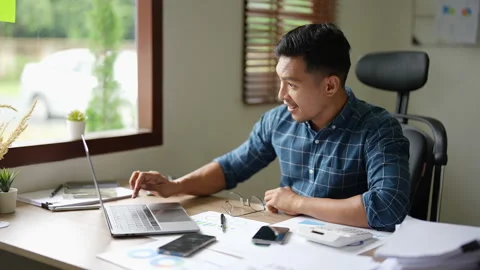 Businessman using laptop Excited the work came out successfully and the goal was Stock Footage 235970875